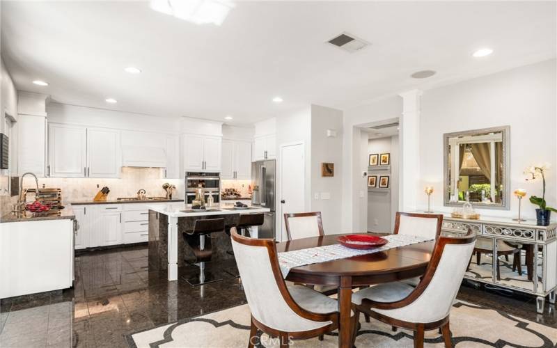 Beautifully updated kitchen with crisp white cabinetry with pull outs and quartz counters.