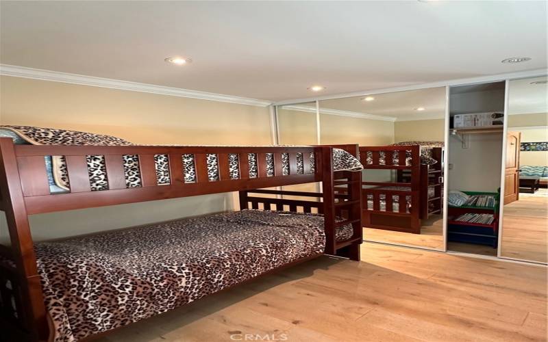 Secondary bedroom with bunk beds and lcloset