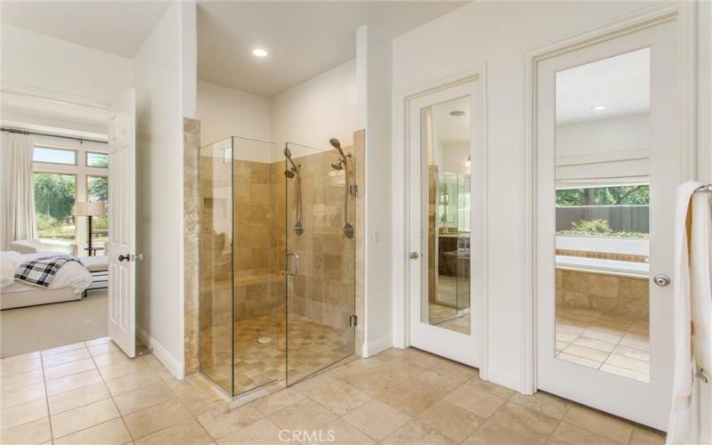 Primary bathroom with two separate walk-in closets