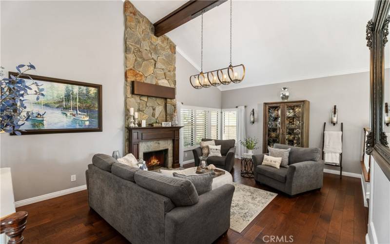 Inviting living room with wood flooring and fireplace.
