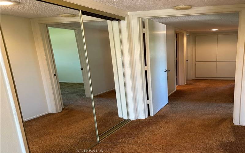 Large hallway closet and linen closet.
