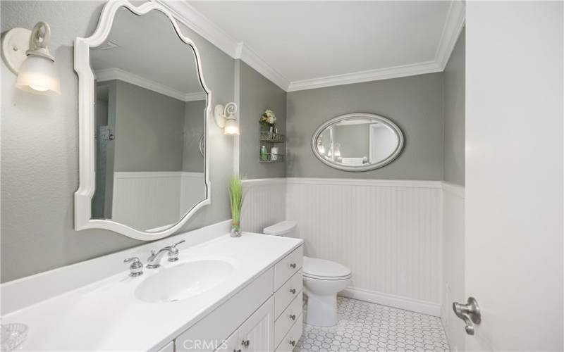 New designer bathrooms - mirrors, sinks, cabinets, connected to shower room in middle...