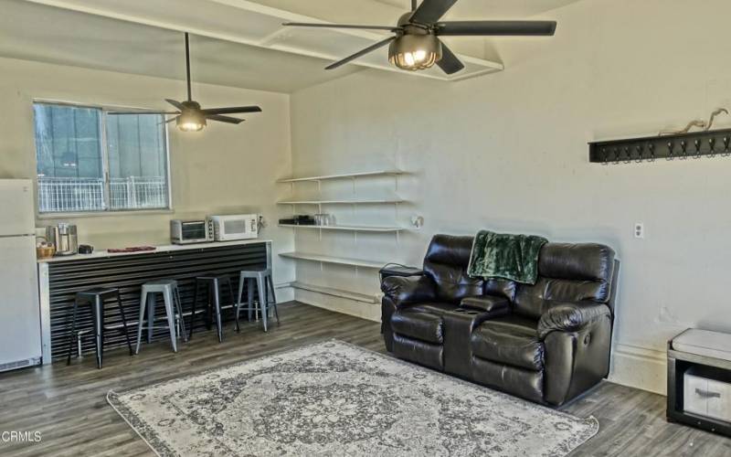 Living Room With Spiral Stairs to Loft