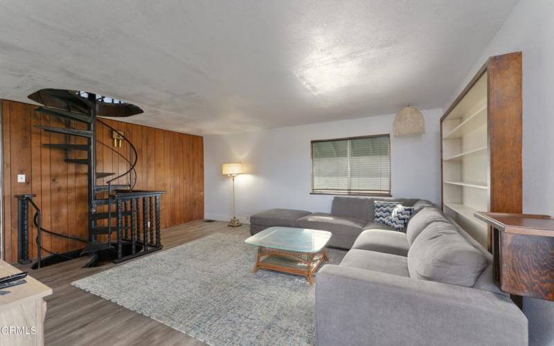 Living Room With Spiral Stairs to Loft