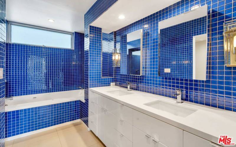 beautifully tiled primary bathroom suite