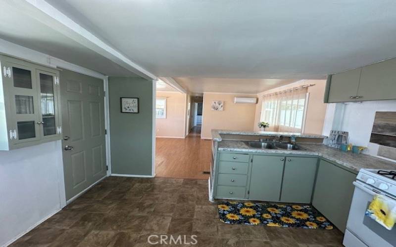 Kitchen . Front door to the left and living room behind it.