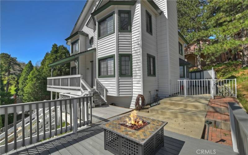 Deck with fire pit and front of the house