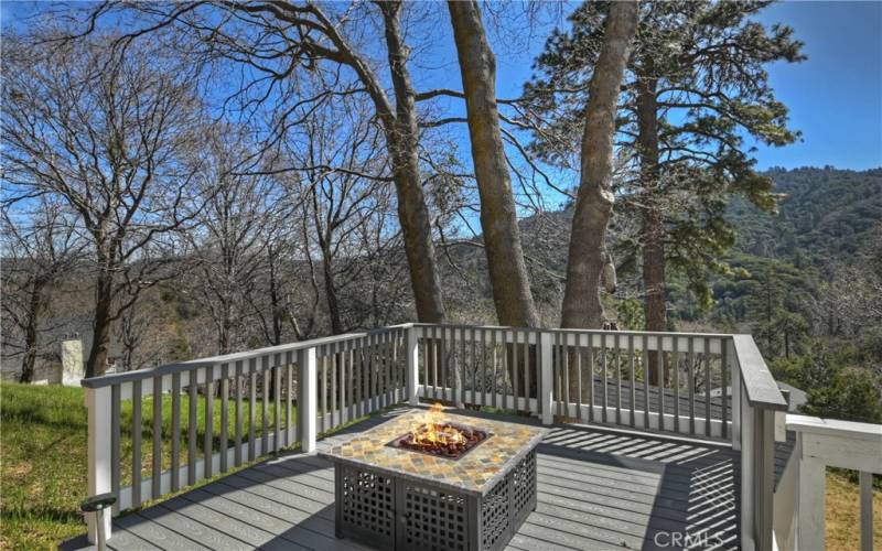 Deck with fire pit  and tree lined views
