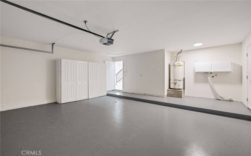 HUGE garage with epoxy flooring and built in cabinets. Washer dryer hookups and water heater