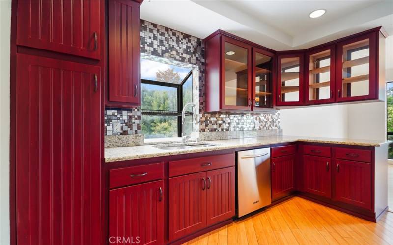 Updated Kitchen in Granite Counters, Tile Backsplashes, Cherry Wood Finish and Contrasting Bamboo Flooring
