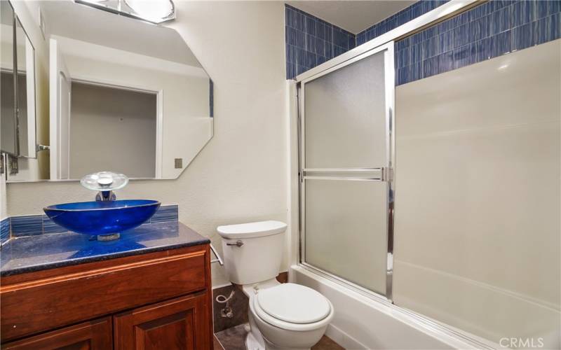 Hall Bath with Cobalt Glass Bowl Basin and Touchless Fixtures