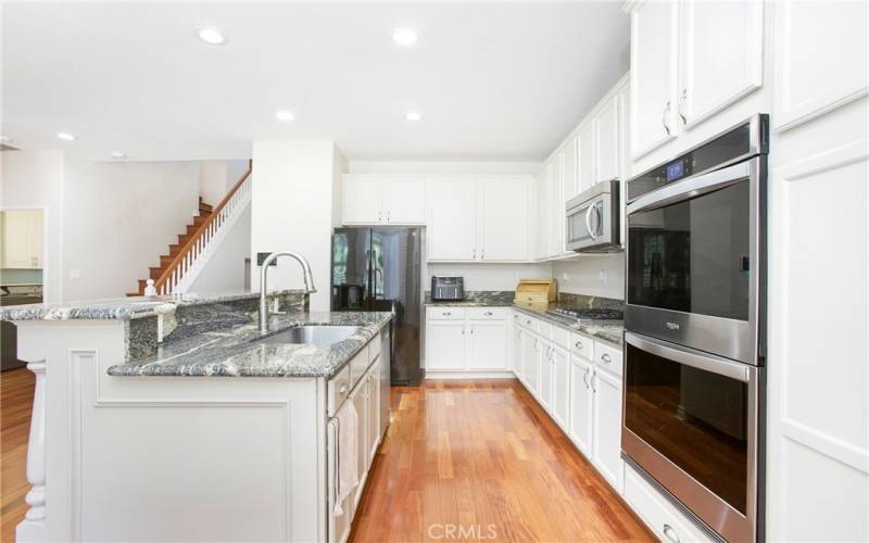 Remodeled kitchen with white cabinetry and newer s.s. appliances.