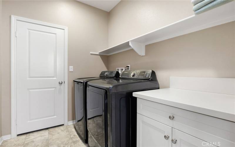 Laundry room with linen closet