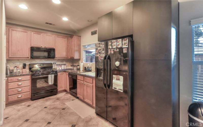 Kitchen with granite countertops and tile backsplash