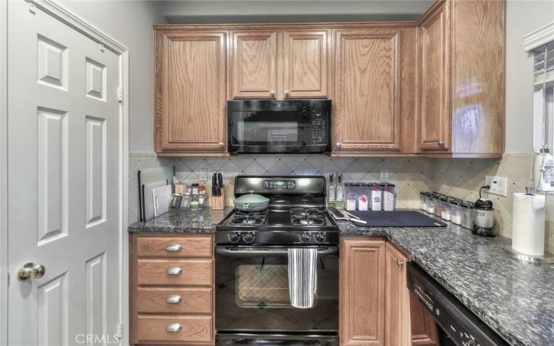 Kitchen with granite countertops and tile backsplash