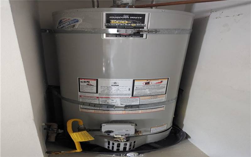 Double strapped water heater located in garage