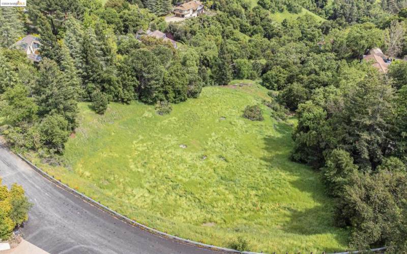 aerial perspective of the land, with the future home nestled in the picturesque left corner