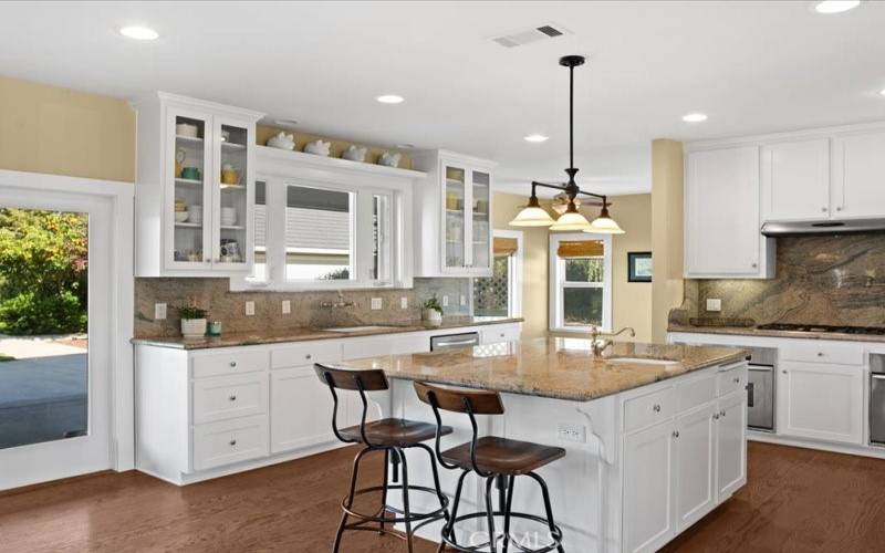 Chefs kitchen with granite countertops and a large center island