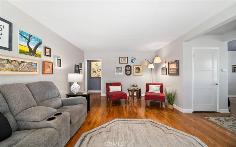 Step into the spacious living room, adorned with beautiful hardwood floors throughout and freshly painted interiors