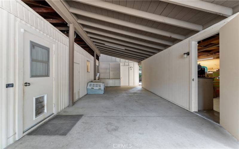 Exterior door from laundry room, garage with workshop and additional workshop straight ahead...
