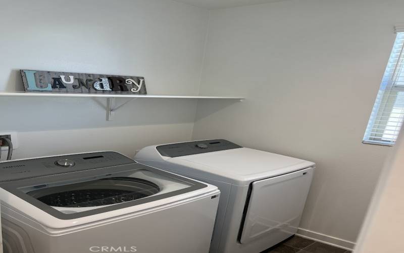 Laundry room with additional storage in room