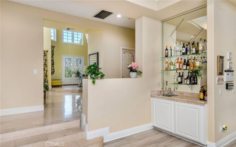Heading towards the less formal area is a wet bar in the family room.