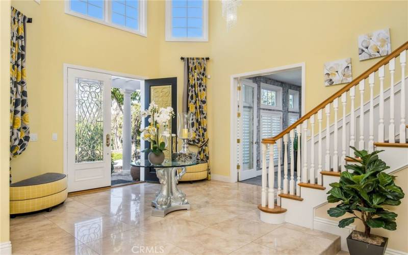 The foyer entrance sets the tone with it’s leaded double doors, travertine flooring and  a beautiful chandelier.