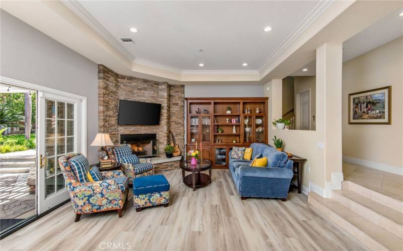 A comfortable family room is has doors leading to the lanai and grounds beyond. The flow of this home is ideal for entertaining.