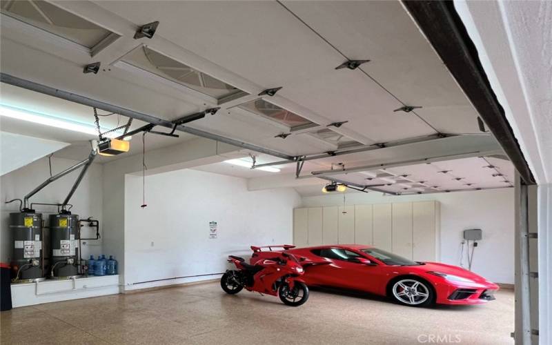 An interior shot of one of the finished four car garages, one of two. Each have two garage door, the taller of the garage door openings is 8’5”. The garage ceilings are 11’ tall.