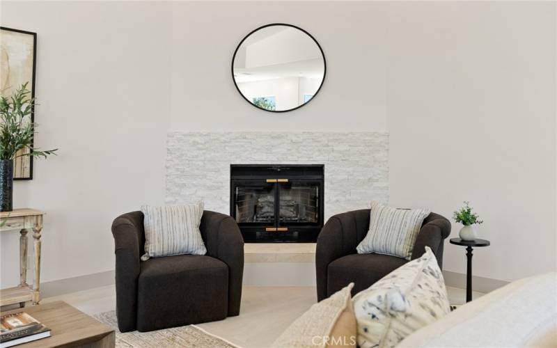 Anchored in the corner of the room is the fireplace with French limestone surround and hearth.