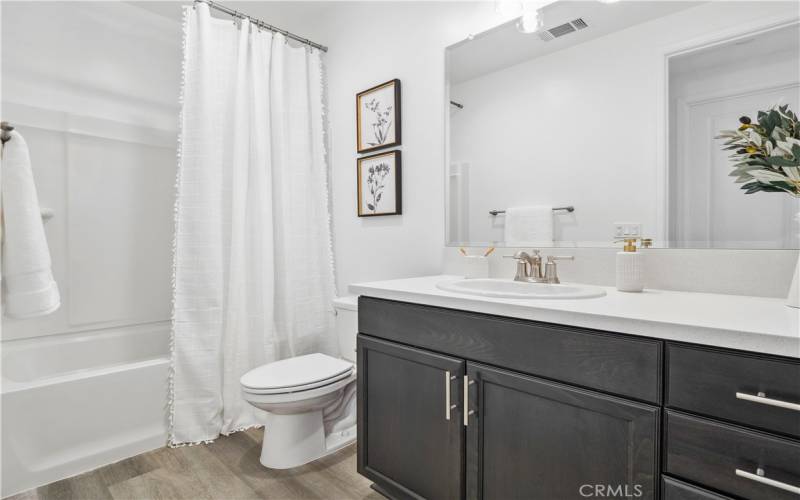 Guest bathroom. Photo is of staged home with same floorplan. Actual home will vary.
