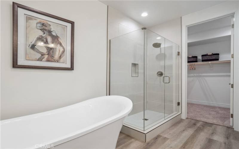 Primary Bathroom/Closet. Photo is of staged home with same floorplan. Actual home will vary.