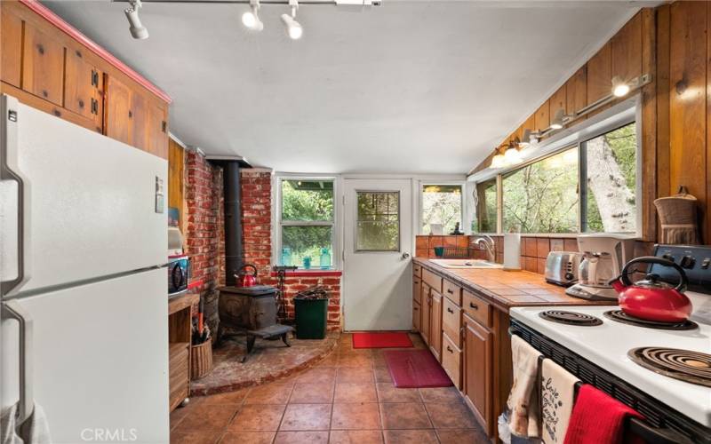 Kitchen comes with dishes and cookware.  And of course a potbellied stove for heat.