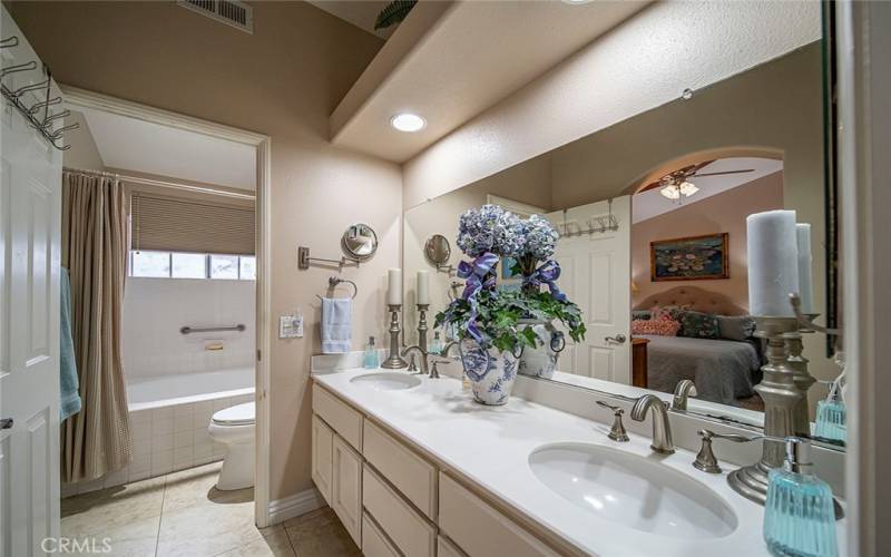 Double Sink Vanity in Primary Bathroom with Separated Toilet and Shower/Soaker Tub Room