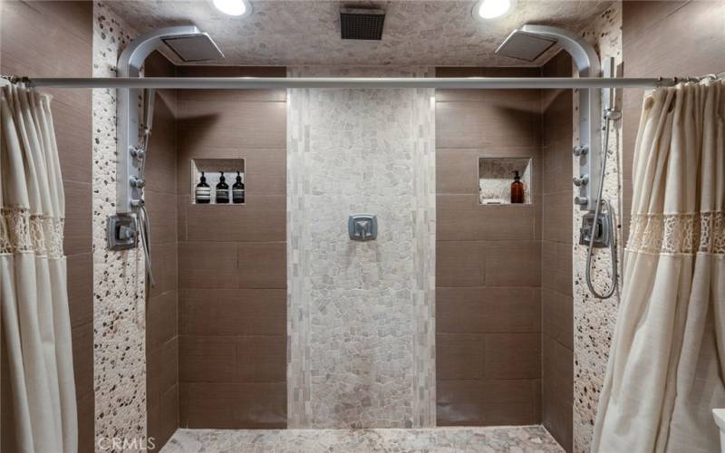 The walk-in shower with dual shower heads.