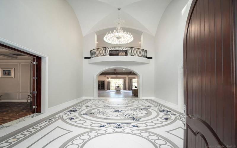 Main entry with 24 high groin vault ceiling and custom designed water jet white and gray marble with blue lapis. Marble archways throughout the house.