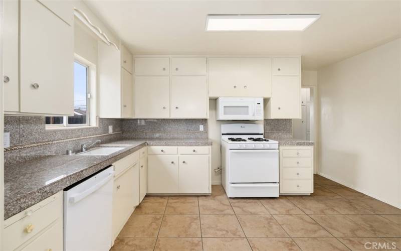 Kitchen with granite tile counter and backsplash