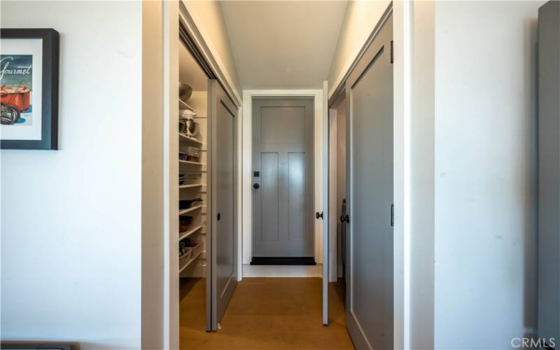 Hallway to pantry and washer dryer closet and garage on main level