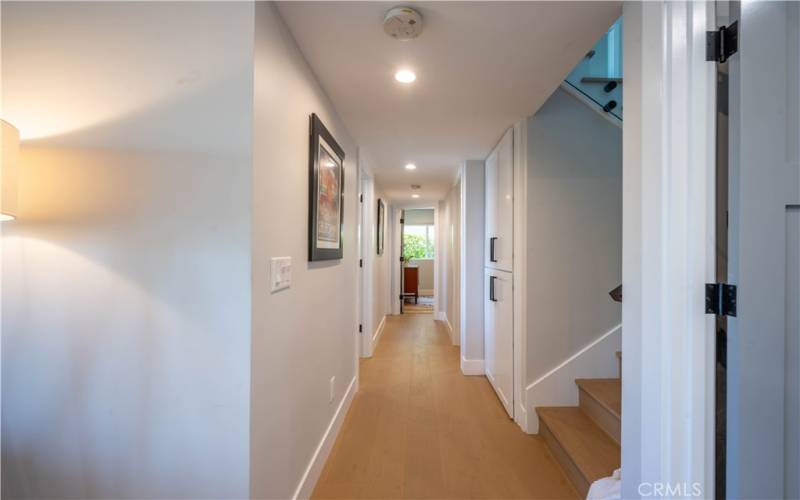 Hallway to 3 bedrooms/office on lower level