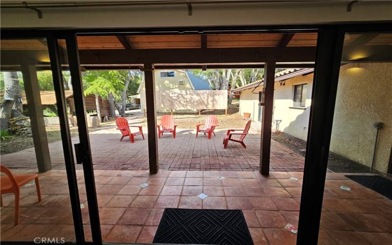 Sliding glass door in living room of main home going out to the relaxing back yard
