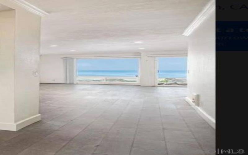 Relax in the living space in front of cozy gas fireplace while looking at the Pacific Ocean!