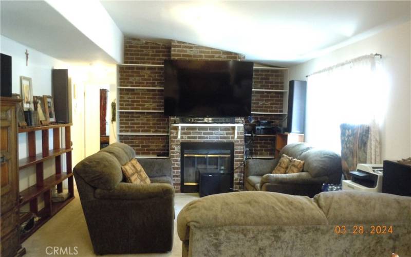 Living room with fireplace and built-in display shelving