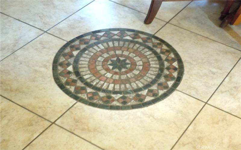 Dining room floor has this tile medallion