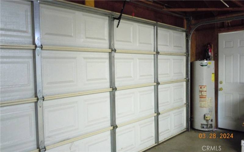 Garage has a garage door opener with roll up garage door