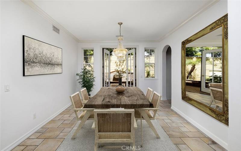 Beautiful formal dining room with French doors leading to spacious yard with pool and spa.