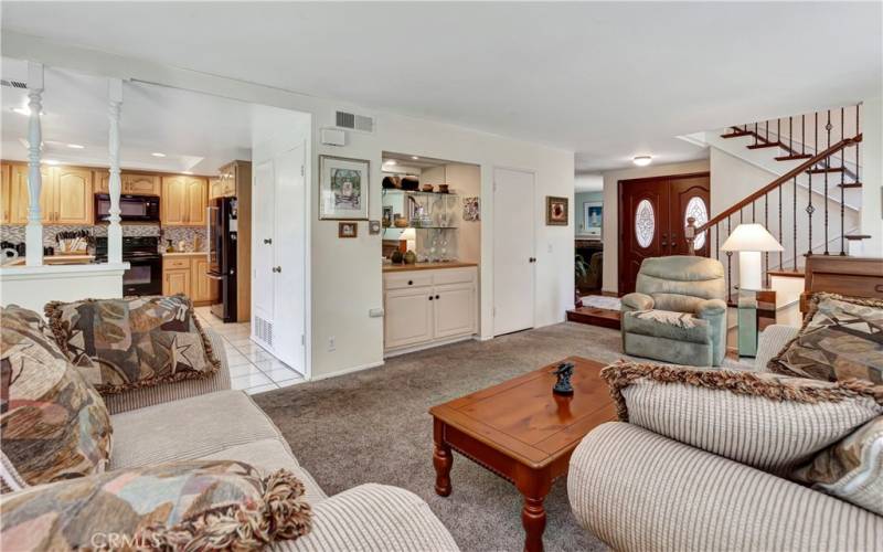 Open and bright living room, kitchen and entry.