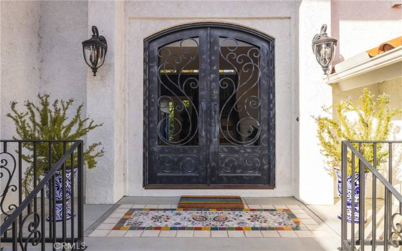 Double iron doors with custom mosaic entry