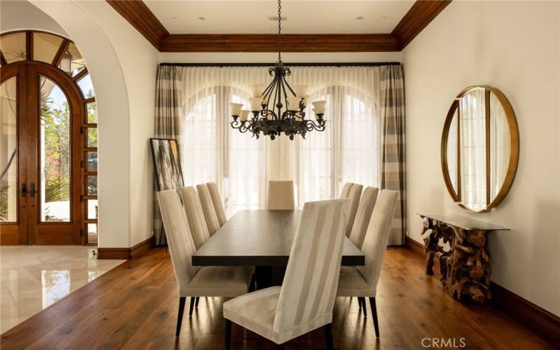 Formal Dining, vaulted ceilings, rustic chandalier, arched doors to courtyard and wood floors
