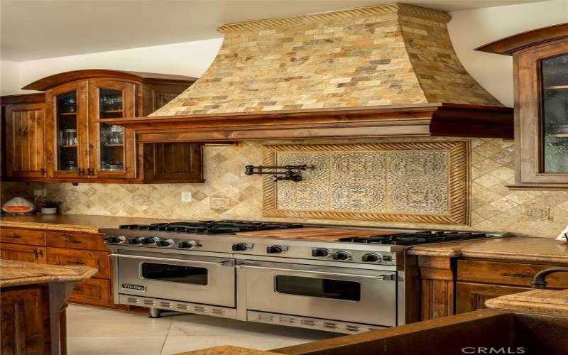 VIKING Stove, with 2 Ovens and a pot filler with mosaic and travertine tile, backsplash and hood