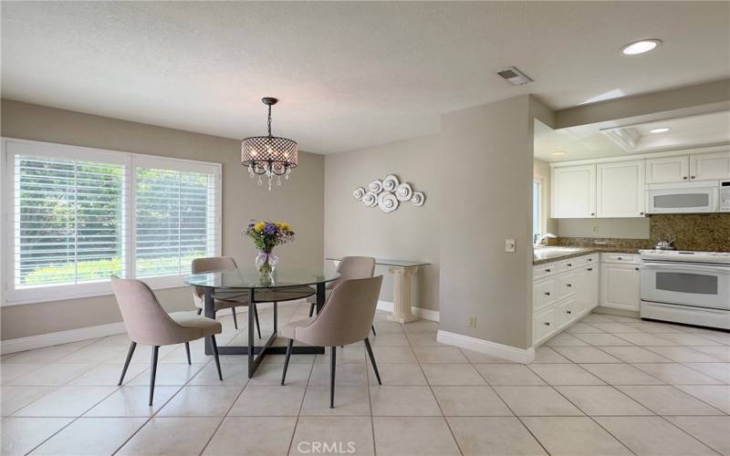 Large Dining Area for entertaining with lush landscape views from newer window with shutters